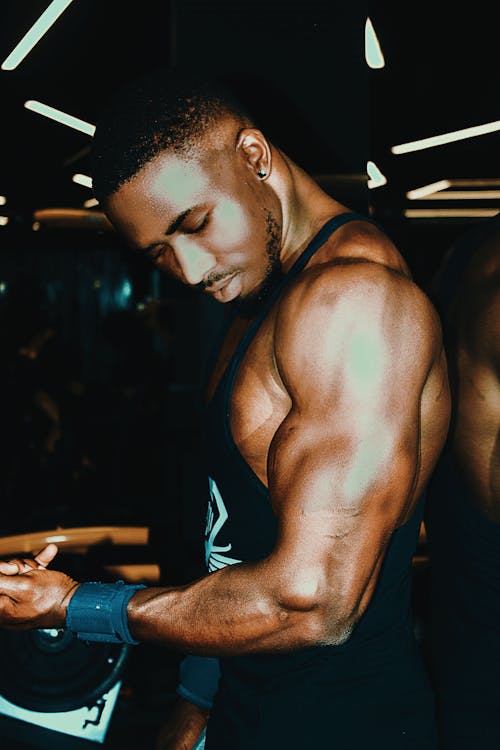Free Man in Tank Top Holding Dumbbell Stock Photo
